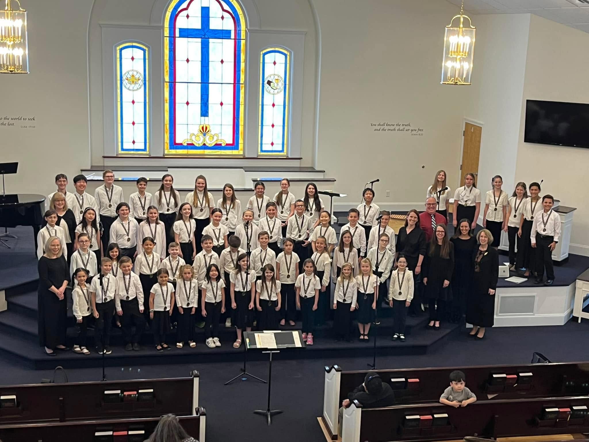 A large children’s choir gathered in a church sanctuary