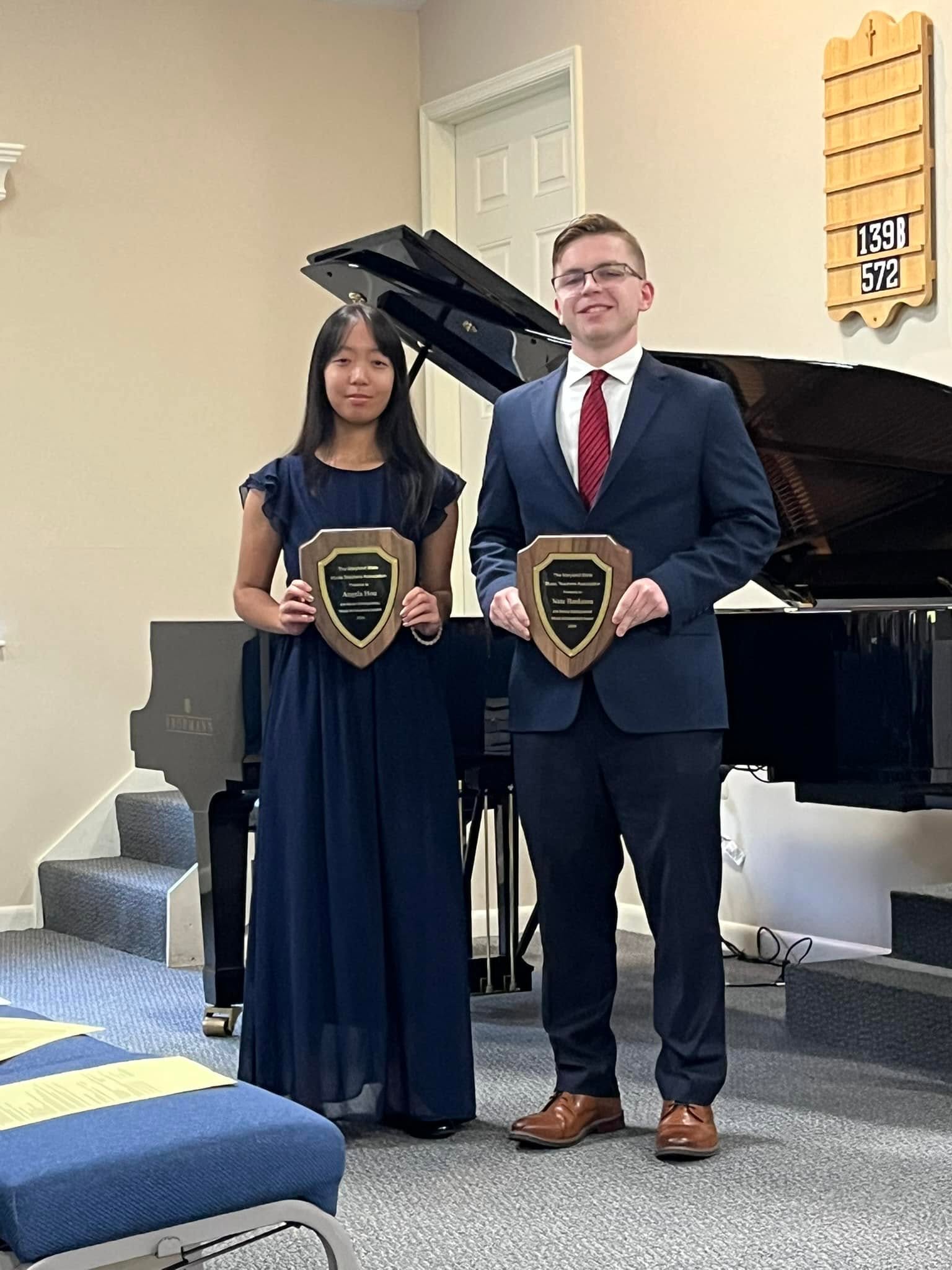 Two accomplished students holding music awards
