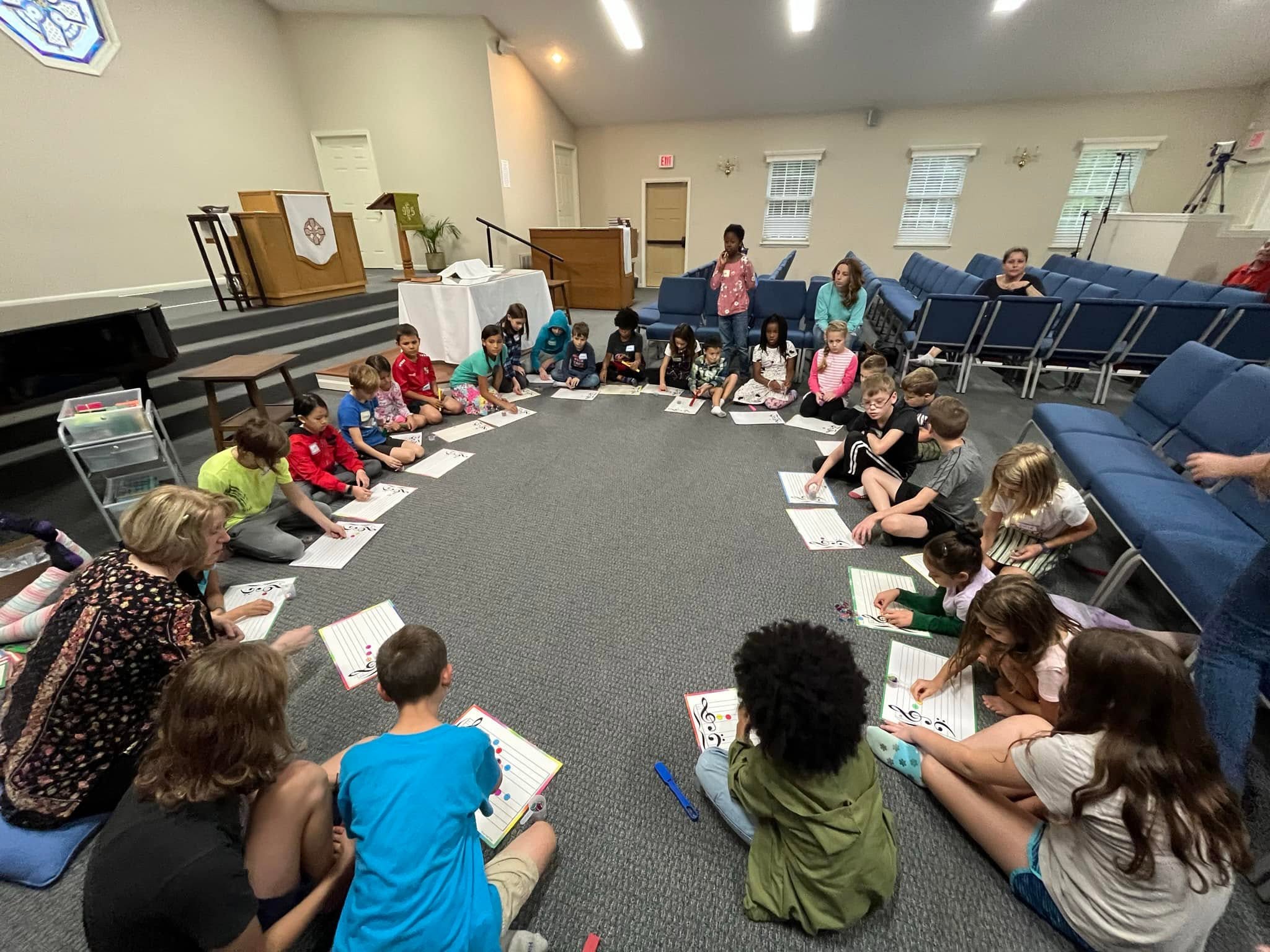 Students gathered in a circle for a group music class
