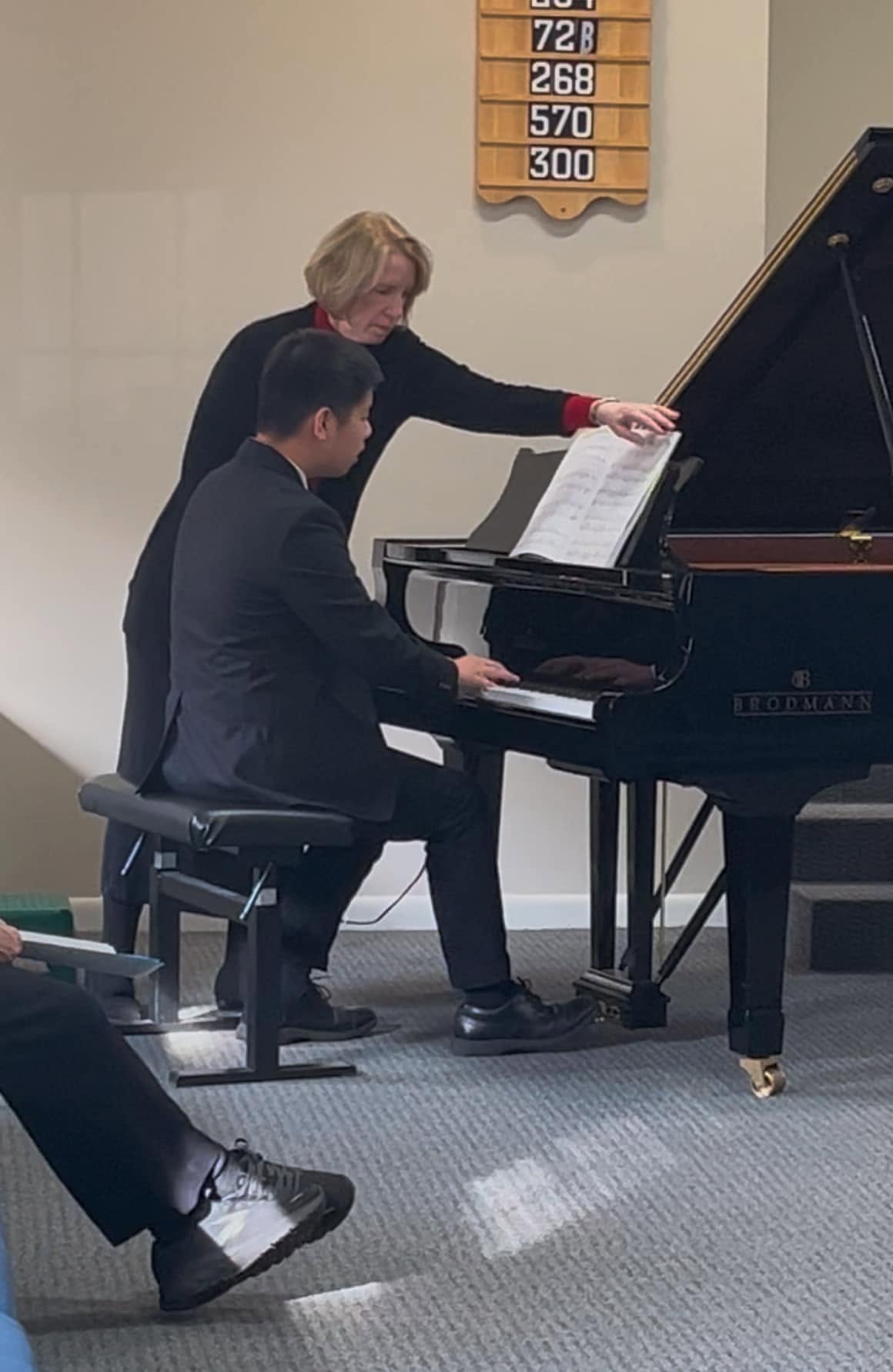 Mrs. Blanchard assisting a pianist during a performance