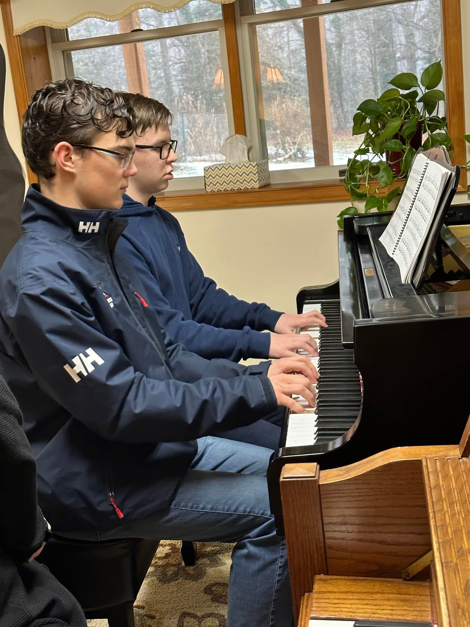Two students performing a piano duet