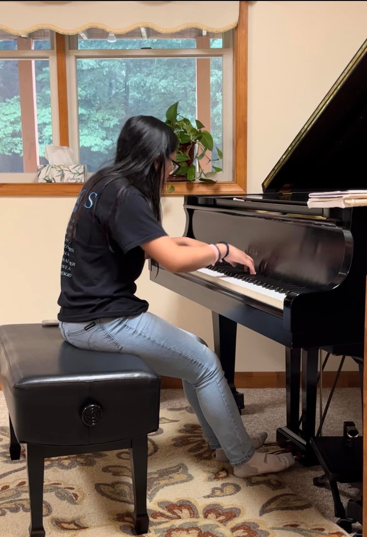 A student practicing at the grand piano