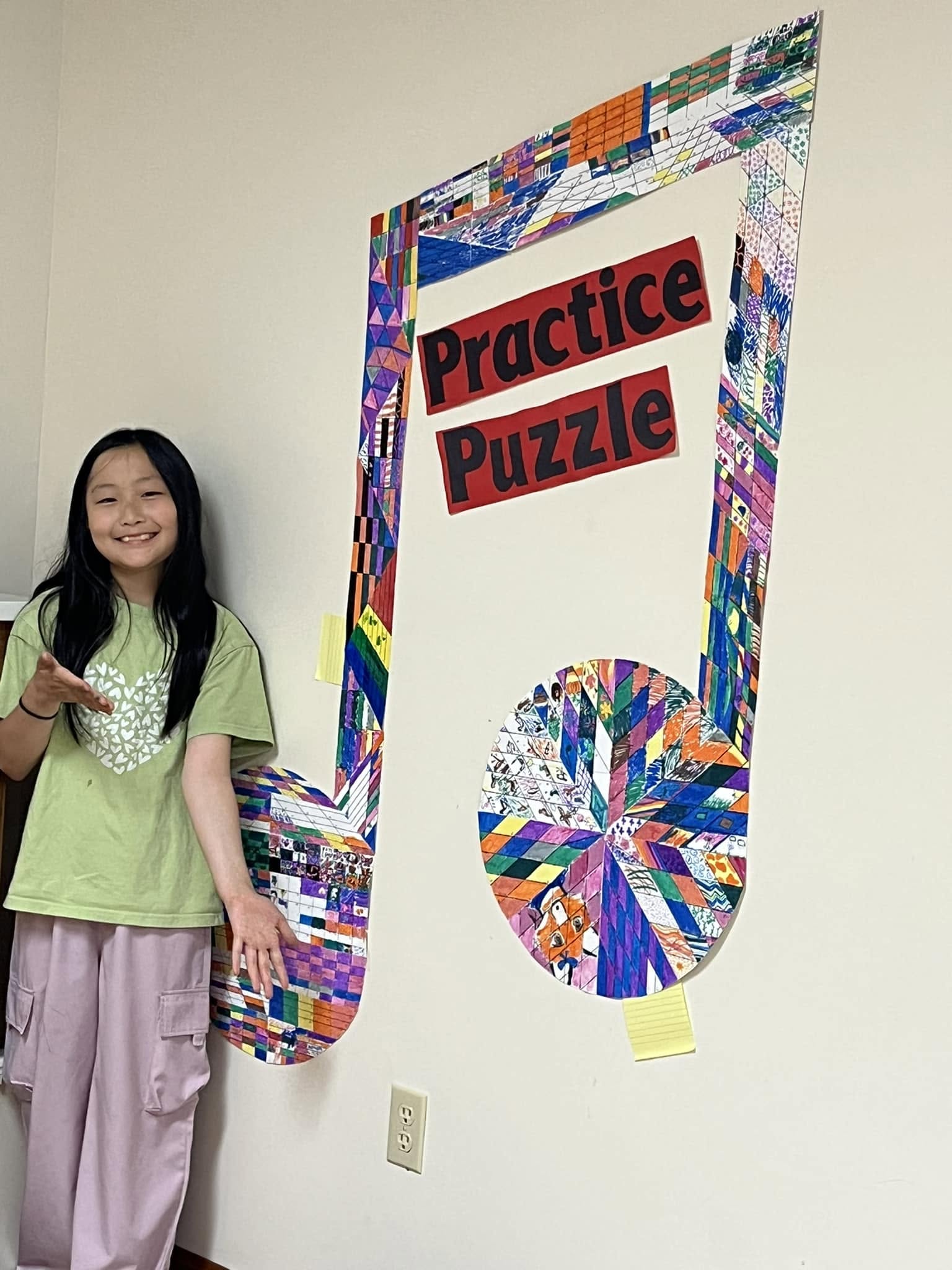 A student beside the completed studio practice puzzle