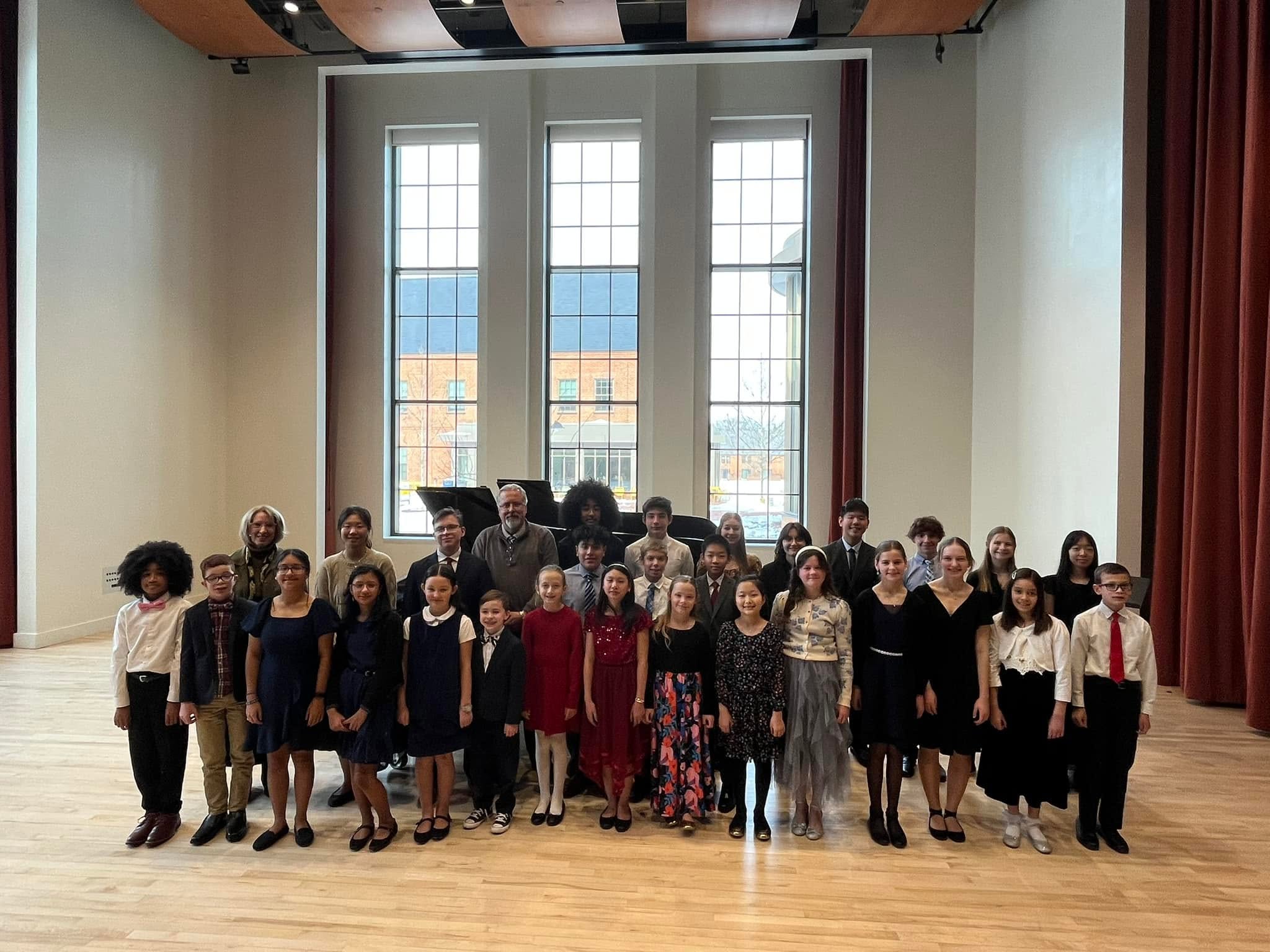 Piano students gathered after a recital